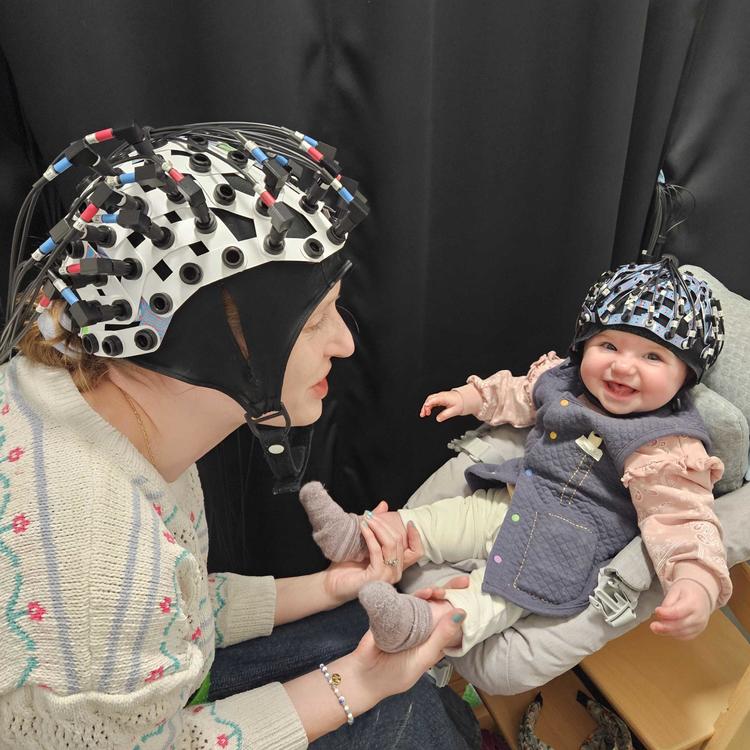 An infant and parent wearing near-infrared spectroscopy, a brain-imaging technology 