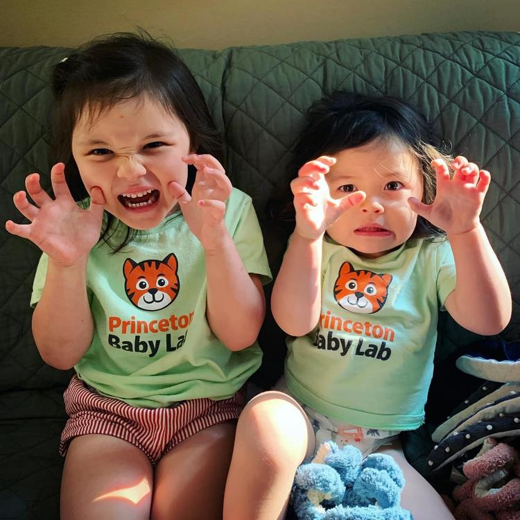 two kids holding their hands up like claws