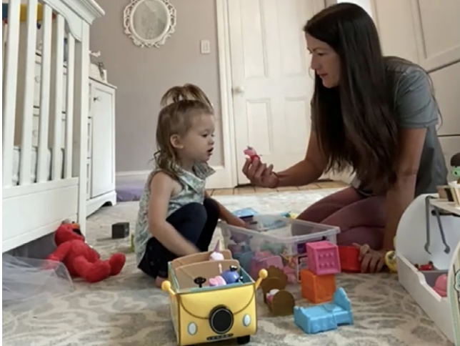 Parent and child play with toys
